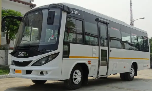 A 35 seater white bus on rent being driven on the highway