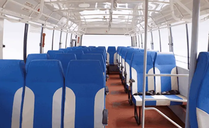 A white tempo traveller with shiny blue accents parked in a residential society in Andheri