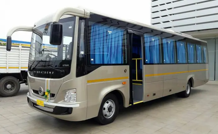 A white tempo traveller with shiny blue accents parked in a residential society in Andheri