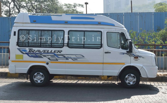 A 12 seater white tempo traveller parked near a neighbourhood in Dadar