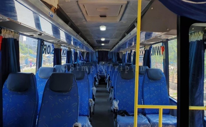 Exteriors of a white 30 seater Bus with Yellow curtains