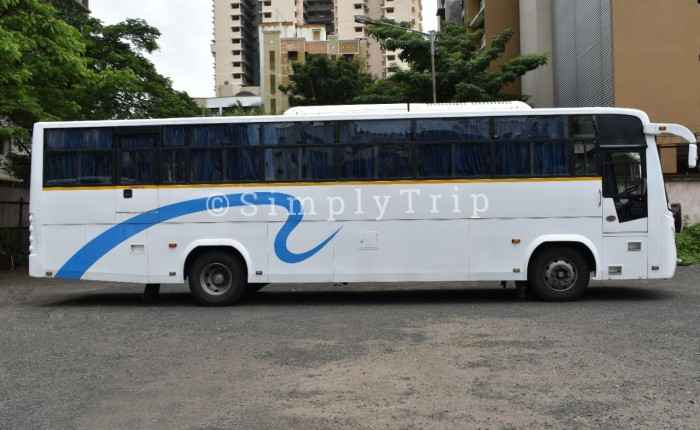 White coloured 40 seater bus with blue curtains
