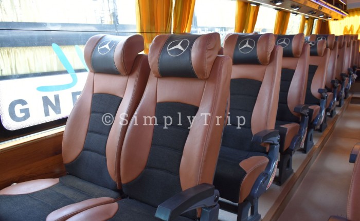 Exteriors of a white 30 seater Bus with Yellow curtains
