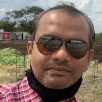 A middle aged man with sunglasses and a red shirt