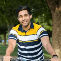 A middle aged man with sunglasses and a red shirt