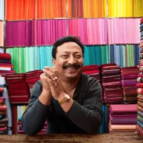 A middle aged man with sunglasses and a red shirt