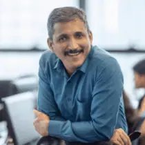 A middle aged man with sunglasses and a red shirt